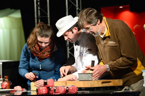 Melton Mowbray Food Festival 2015 : ©Lionel Heap : Stephen Hallam (centre) helps show visitors Carolise and Ken hand raise a Melton Mowbray Pork Pie in the demonstration theatre.